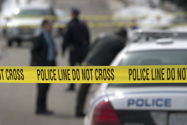 a crime scene and police car with a line of police tape